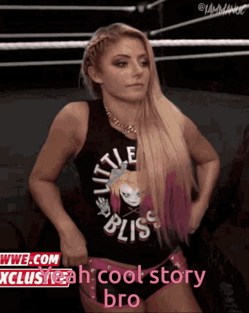 a woman wearing a little bliss tank top stands in a wrestling ring