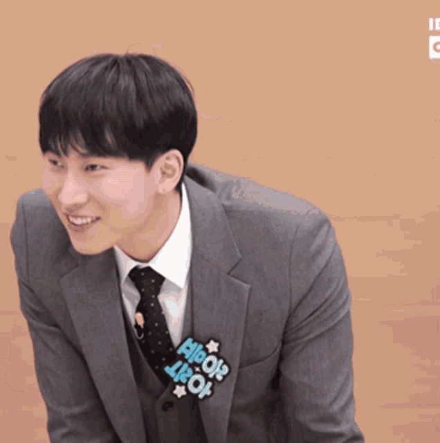 a man in a suit and tie has a sticker on his necktie that says allow
