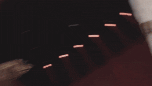 a blurry photo of a person 's face with a few lights in the background