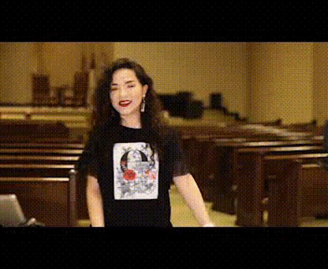 a woman wearing a black t-shirt with a picture of a man on it