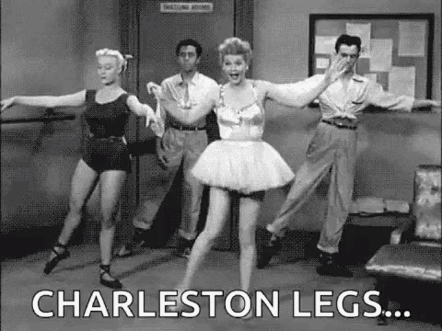 a group of ballerinas are dancing in a room with a man .