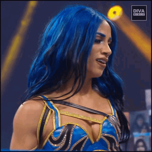 a woman with blue hair and a diva circle logo on the bottom