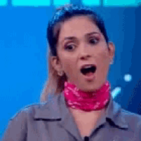 a woman wearing a pink bandana around her neck and a ponytail is making a funny face .