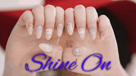 a close up of a woman 's nails with the words shine on