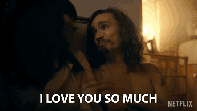a man is laying on a bed with a woman and says i love you so much on the bottom