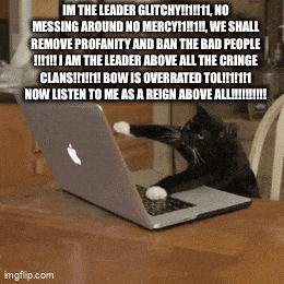 a cat is sitting in front of an apple laptop computer