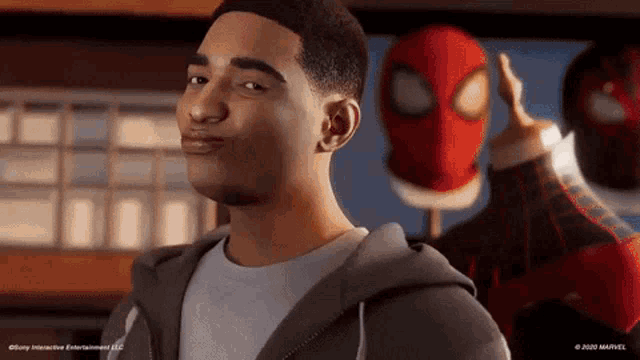 a man is standing in front of a spider man mask .