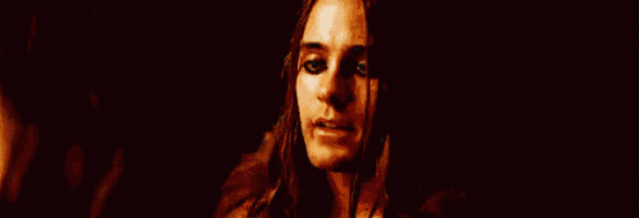 a close up of a woman 's face with a dark background .