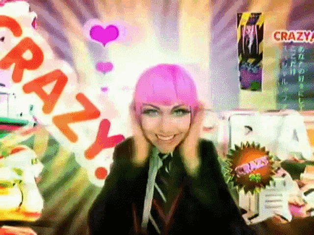 a woman with pink hair is standing in front of a banner that says crazy