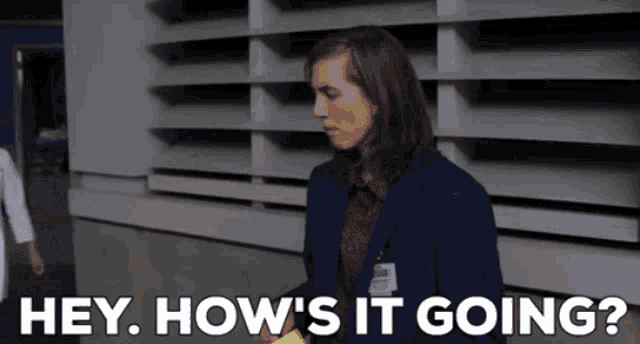 a man in a suit says " hey how 's it going " while holding a banana