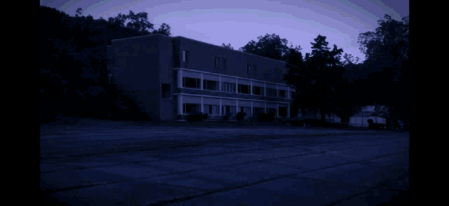 a building with smoke coming out of it and trees in the background