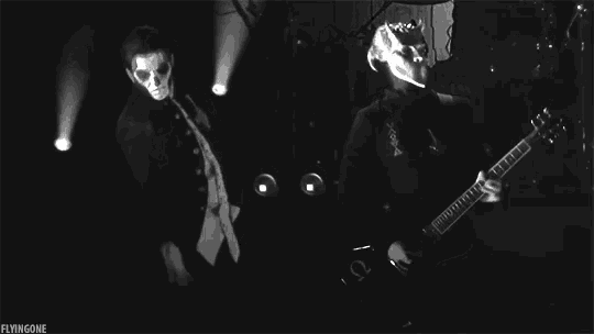 a black and white photo of a man playing a guitar with the caption flyinggone