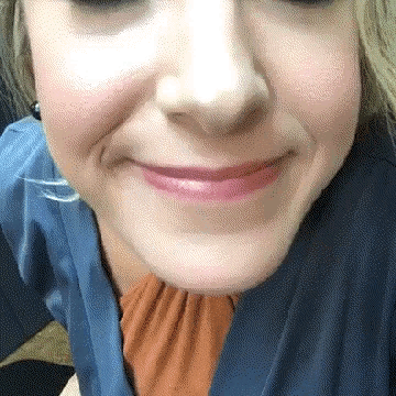 a close up of a woman 's face with a slight smile on her face .