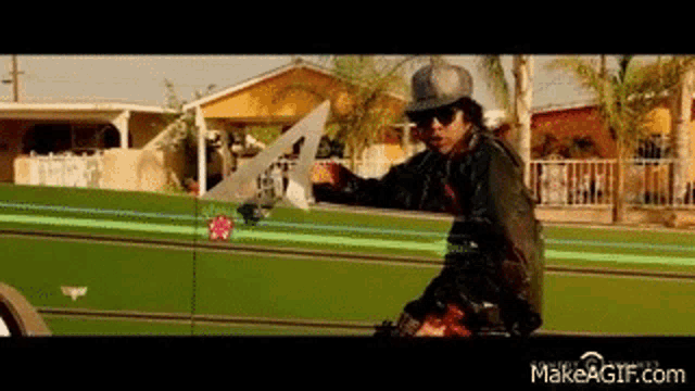 a man is holding a saw while riding a motorcycle .