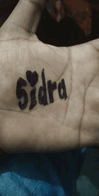 a person has the name sidra written on their wrist