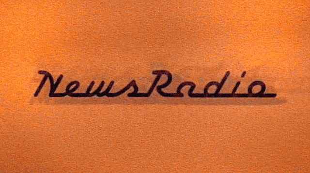 a close up of a news radio logo