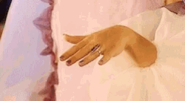 a woman 's hand with a diamond ring on it