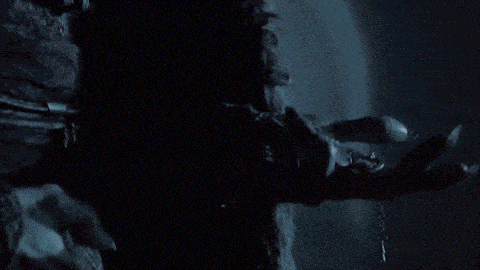 a close up of a man 's face with a chain around his wrist