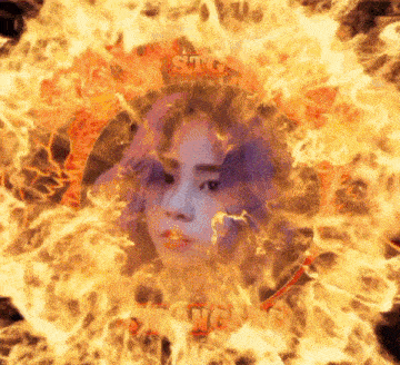 a woman with purple hair is surrounded by flames with the word sting on it