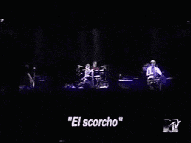 a group of people on a stage with the words " el scorcho " in white