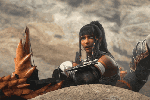 a woman laying on a rock with a bow and arrow