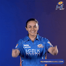 a woman wearing a blue shirt that says six