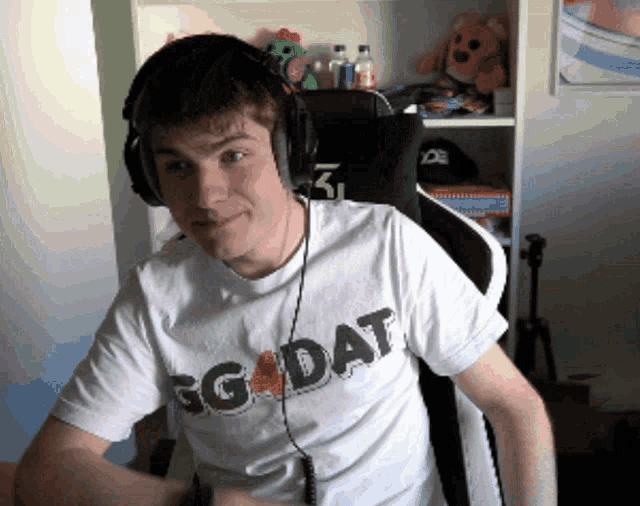 a young man wearing headphones and a t-shirt that says gg dat