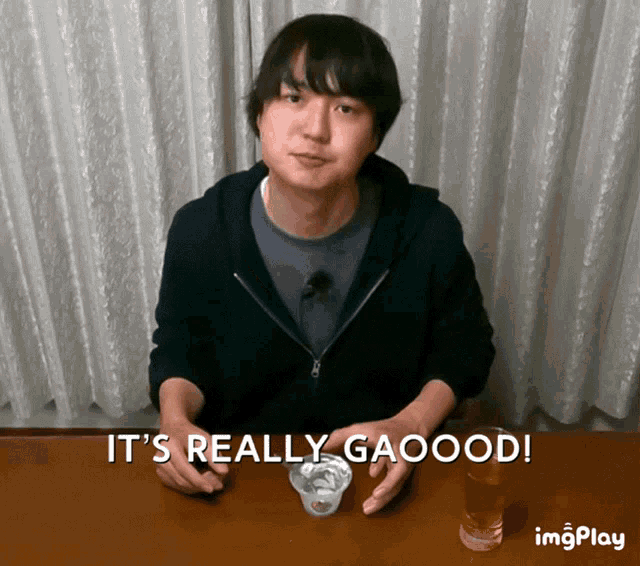 a man sitting at a table with the words it 's really gaood
