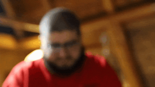a blurry photo of a man wearing a red shirt