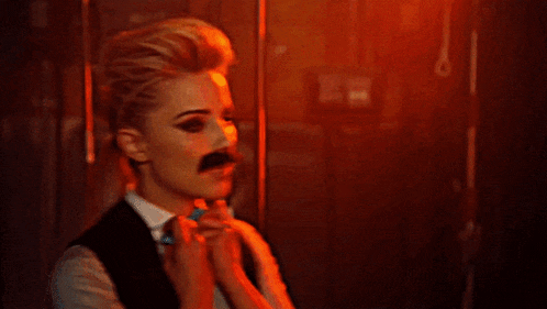 a woman is wearing a fake mustache and bow tie