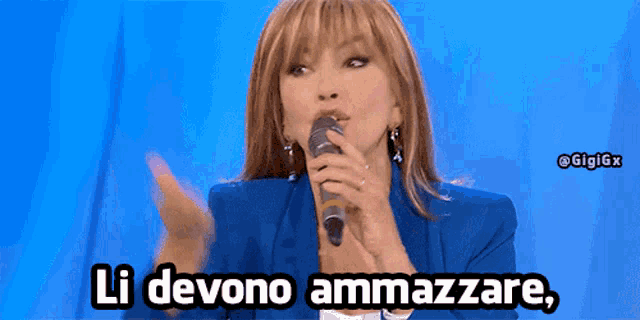 a woman in a blue jacket is holding a microphone and says li devono ammazzare