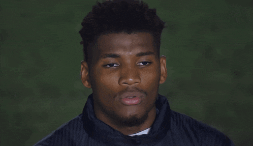 a young man with his eyes closed and his mouth open