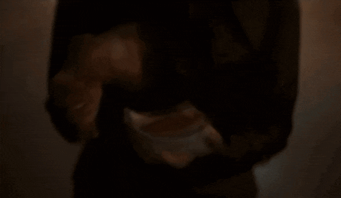 a man is talking on a cell phone in the dark