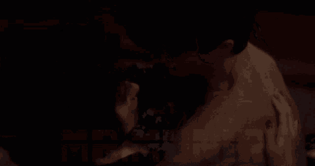 a man and a woman are kissing in a dark room with a watermark that says mr. mr.