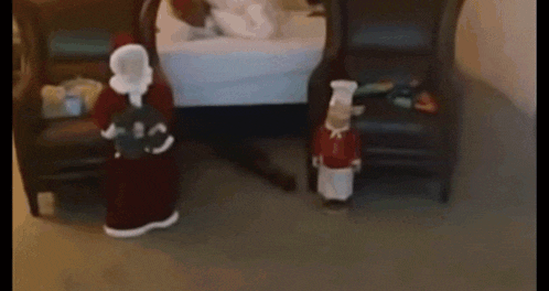 a man is doing a push up in front of a santa claus statue