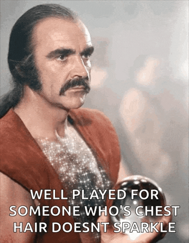 a man with a mustache is holding a ball and says well played for someone who 's chest