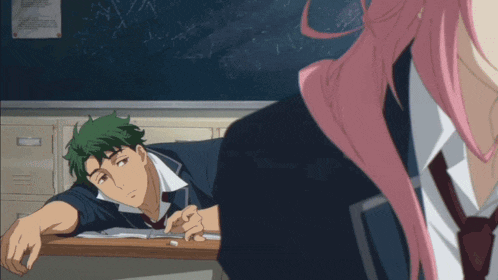 a girl with pink hair looks at a boy with green hair laying on a desk