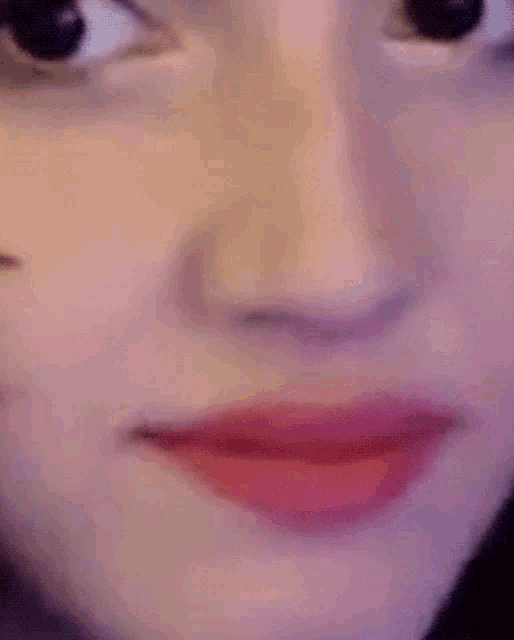 a close up of a woman 's face with red lipstick