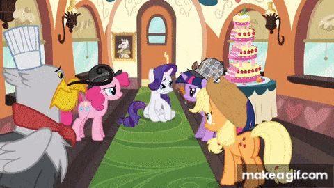 a group of ponies are standing in a room with a cake on a table