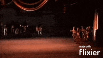 a group of people are dancing on a stage with the words made with flixier in the upper right corner