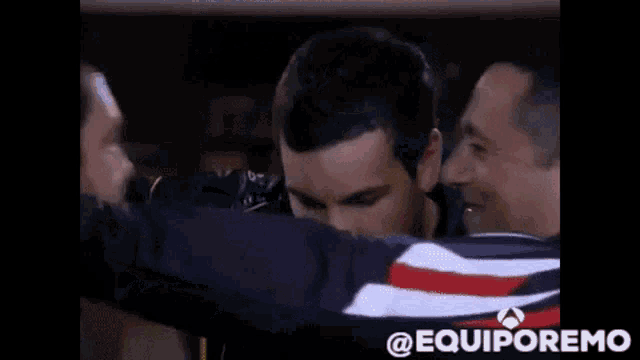 a couple of men hugging each other with the words " @equiporemo " at the bottom
