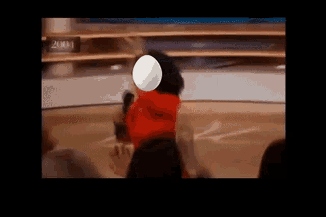a woman in a red dress is holding a white balloon in front of her face ..