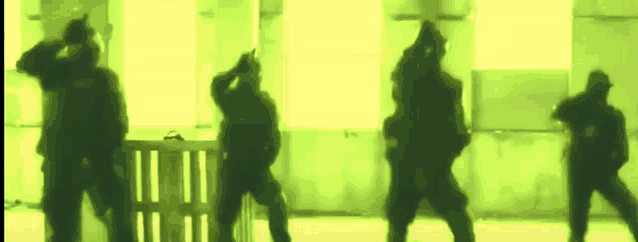a group of soldiers are standing in a room with green lights behind them