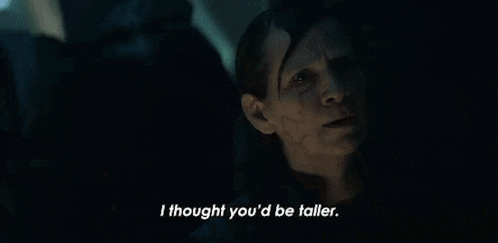 a woman is sitting in a dark room and says `` i thought you 'd be taller '' .
