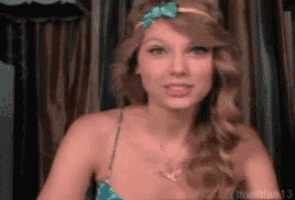 a woman wearing a headband and a necklace with the number 13 on the bottom right