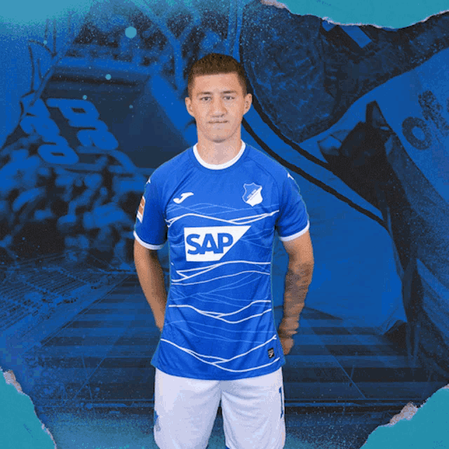 a young man wearing a blue shirt with the word sap on it