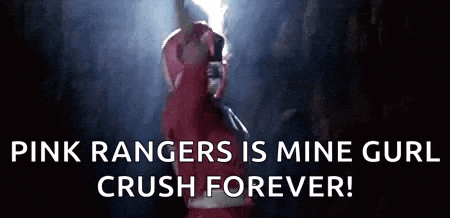 a pink ranger from the power rangers is holding a lightning bolt in the dark .
