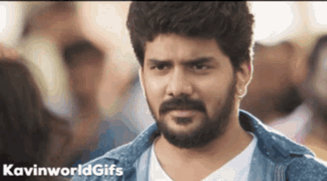 a man with a beard is wearing a denim jacket and a white shirt ..
