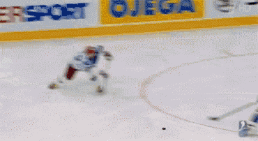 a hockey game is being played in front of a sign that says zepter ze