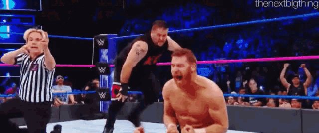 a wrestler is jumping over another wrestler in a wrestling ring .